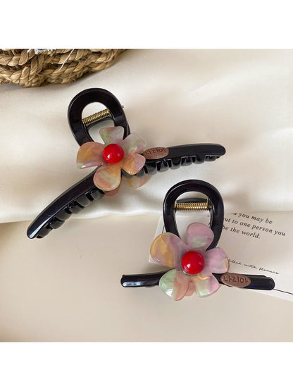 Side view of Beau flower claw clip highlighting curved prongs