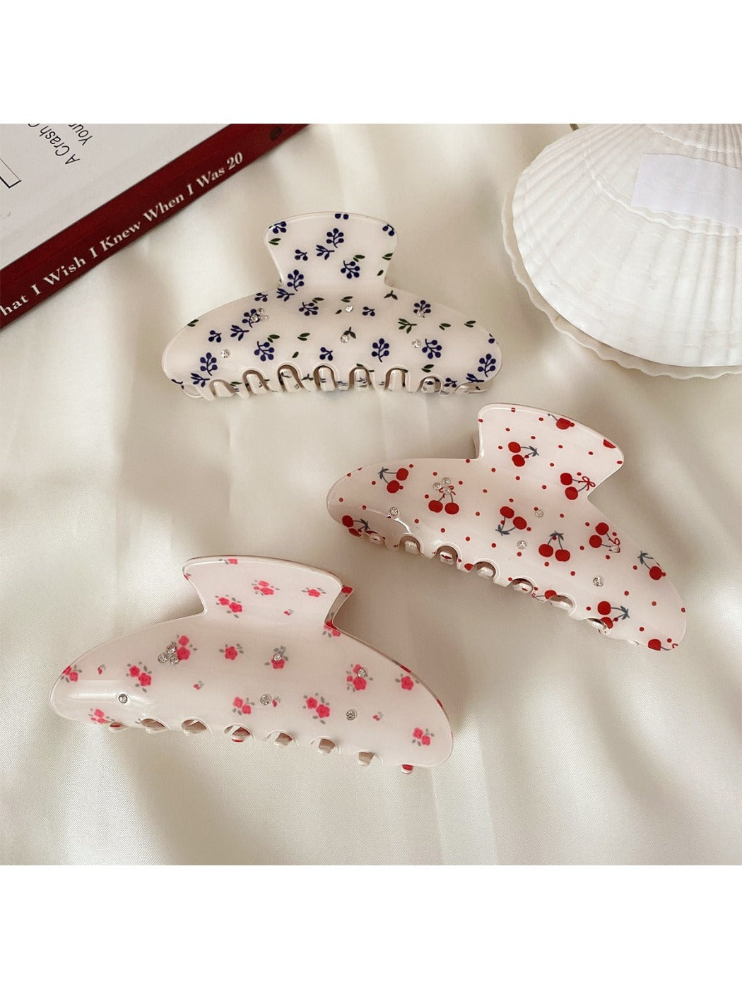 Beau half moon hair claw clip with colorful printed design on white background