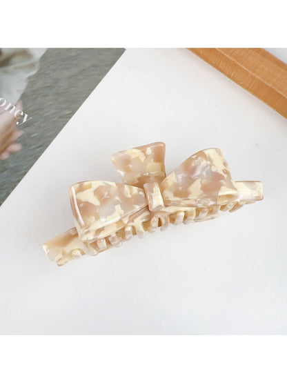 Beau bow shaped claw clip in glossy finish with metal spring detail