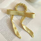 Gifty satin yellow ribbon bow scrunchie worn on wrist as accessory