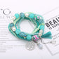 Lovra bracelet worn on wrist displaying tree-shaped tassel pendant and colorful beads