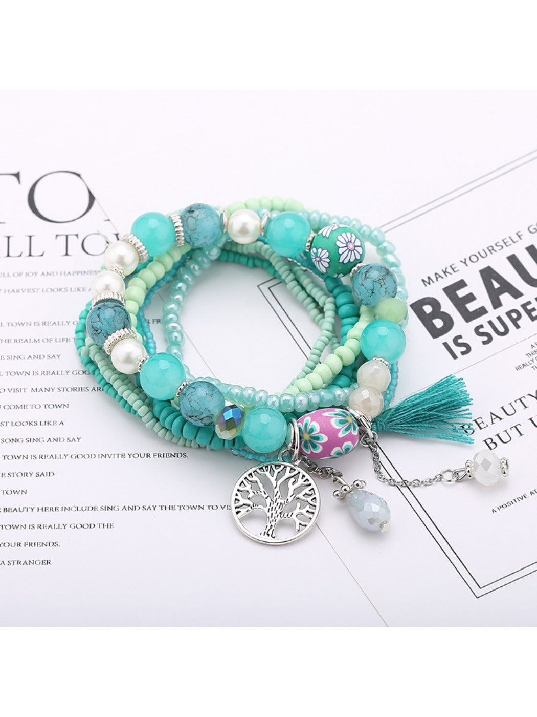 Lovra bracelet worn on wrist displaying tree-shaped tassel pendant and colorful beads