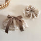 Beau Polka Dot Lace Scrunchie in black with white dots, showing full circular shape
