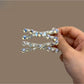 Close-up of Beau sparkly crisscross bar hair clip highlighting glitter details