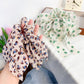 Close-up of Gifty vintage floral printed scrunchie fabric texture