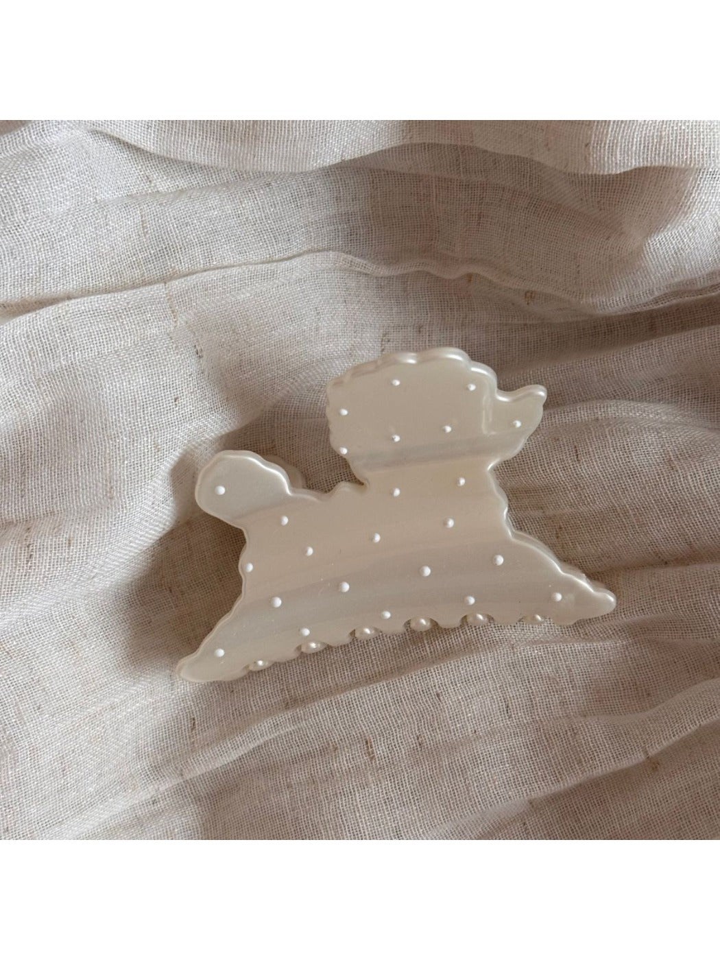 Beau hair clip styled in hair, highlighting the puppy shape and polka dot design