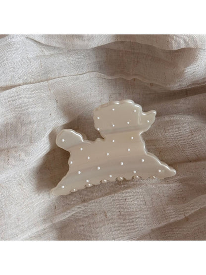 Beau hair clip styled in hair, highlighting the puppy shape and polka dot design