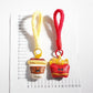 Keypus keychain attached to a set of keys with fries and coffee cup charms