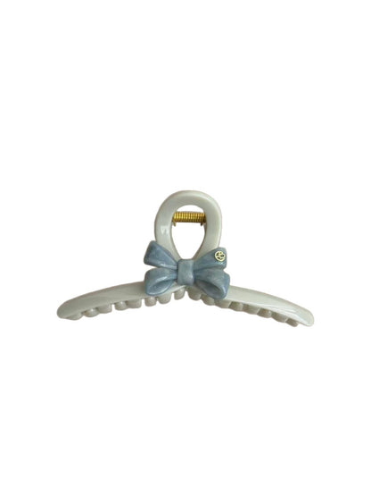 Close-up of blue bow hair clip showing metal clasp detail