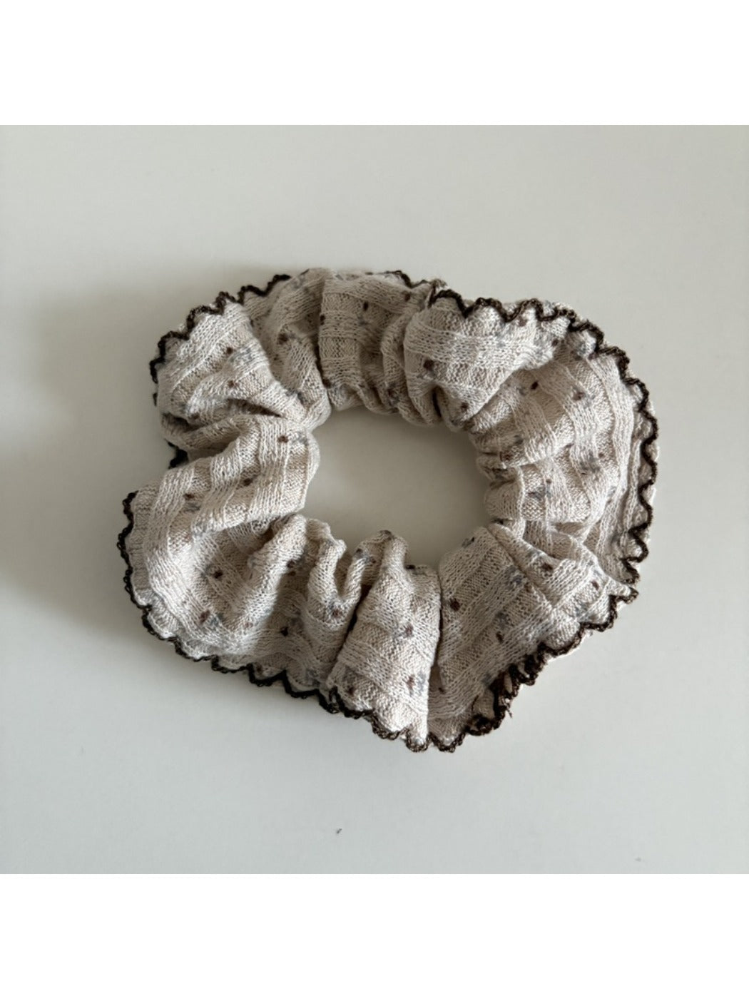Side view of Gifty scrunchie highlighting its gathered fabric texture