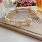 Close-up of the twisted knot detail on the soft white headband