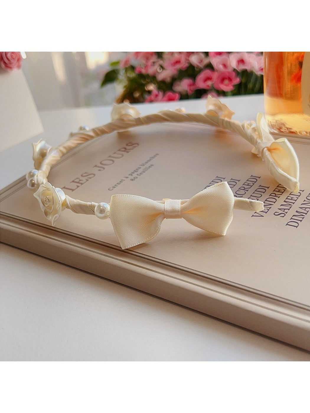 Close-up of the twisted knot detail on the soft white headband