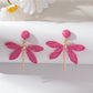 Detailed shot of raffia weaving on dragonfly shaped earring