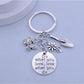 Butterfly flower keychain attached to a set of keys on a wooden surface