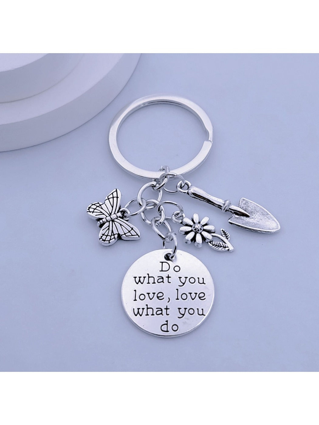 Butterfly flower keychain attached to a set of keys on a wooden surface