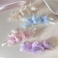 Elegant banana hair clip decorated with gold butterfly accents on a white background