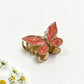 Beau butterfly hair clip securing medium-length hair on a model