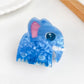 Beau animal shaped hair claw clip in beige on a neutral background