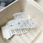 Beau half moon claw clip shown from top angle emphasizing minimalist style