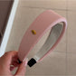 Headband folded to display soft fabric and vibrant gentle color pattern
