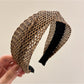 Model adjusting Gifty woven cross headband with casual outfit