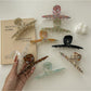 Beau claw clip held in hand showing size and gradient color transition