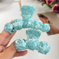 Side view of Beau hair claw clip highlighting wavy design and spring mechanism