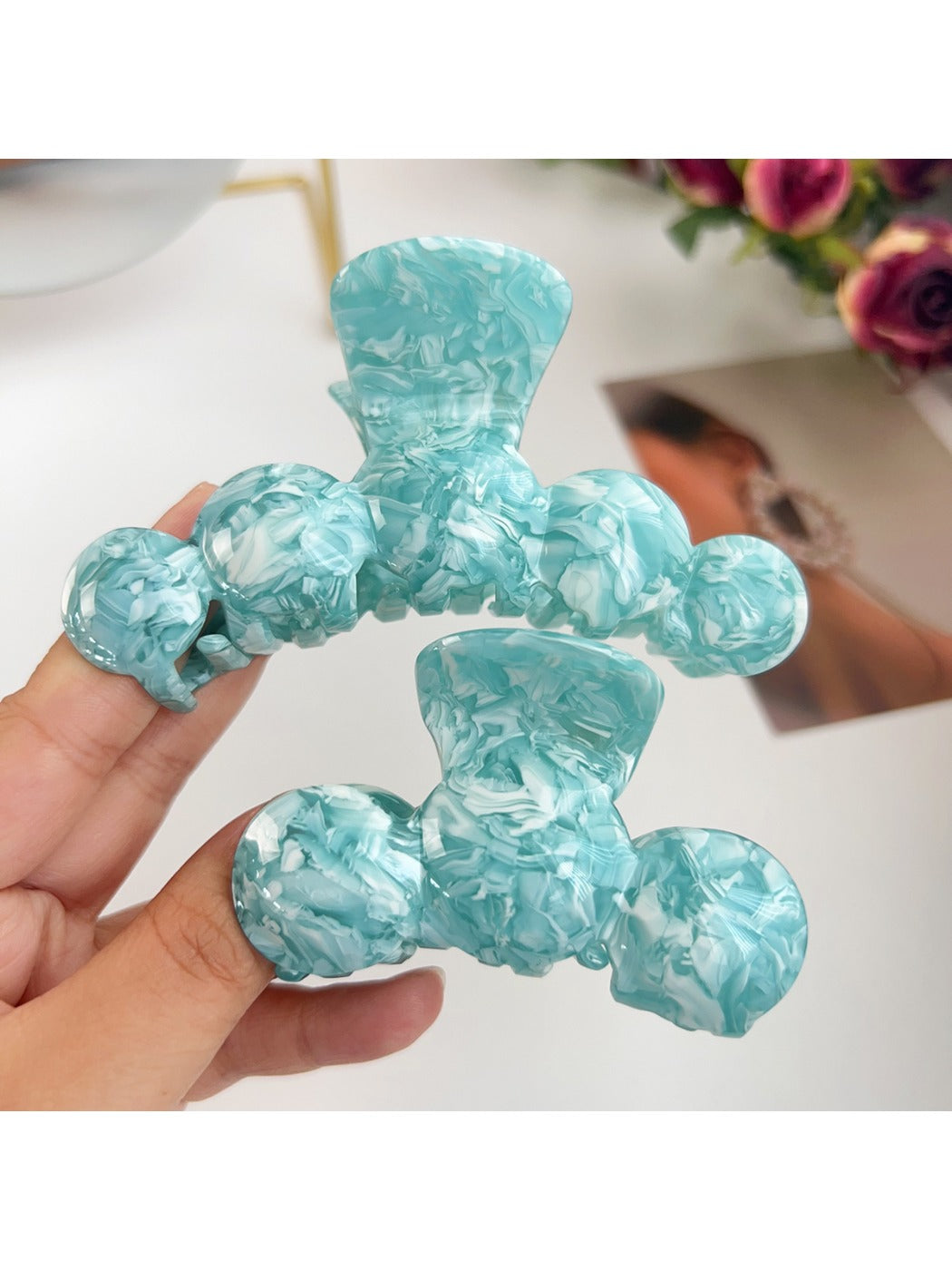 Side view of Beau hair claw clip highlighting wavy design and spring mechanism