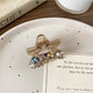 Beau five pointed star claw clip resting on a white surface with soft shadows