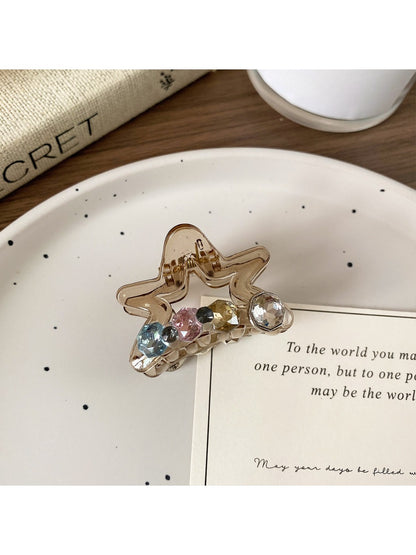 Beau five pointed star claw clip resting on a white surface with soft shadows