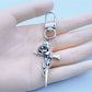Rose gold cross-shaped keychain with intricate design on white background