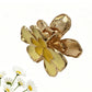 Close-up of Beau flower hair clip showing detailed fabric petals and textured gold center