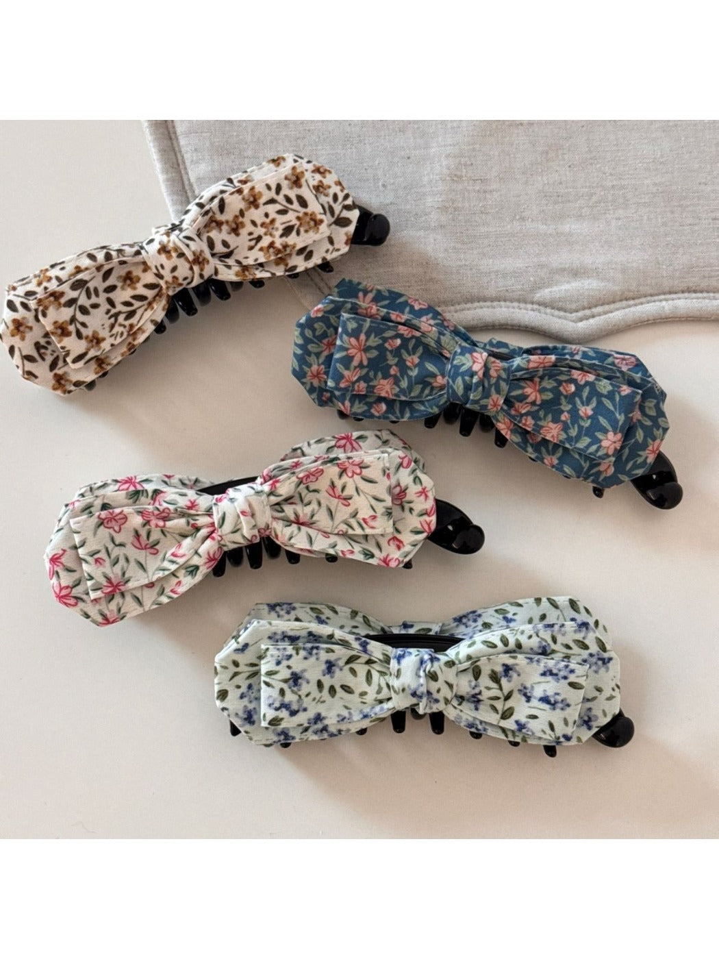 Close-up of Beau bow hair clip showing textured oil painting pattern in blue tones