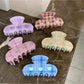 Close-up of Beau Fresh Plaid Acetate Hair Clip highlighting glossy acetate material