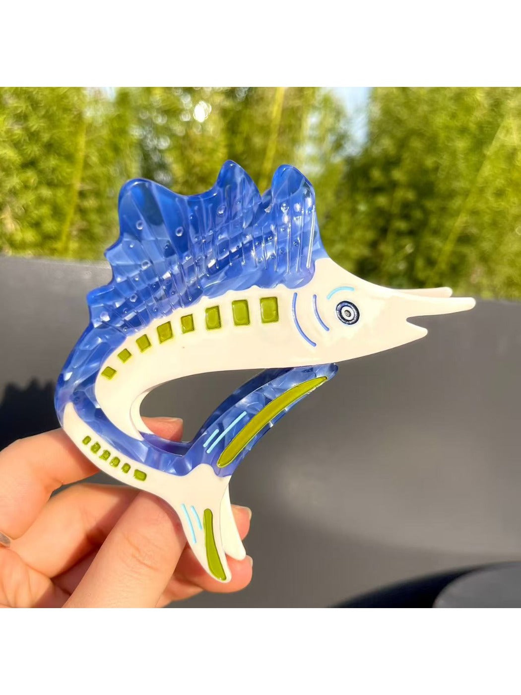 Beau sturgeon claw clip placed on wooden surface with natural lighting