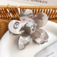 Close-up of flower hair claw clip clasp mechanism with colorful petal edges