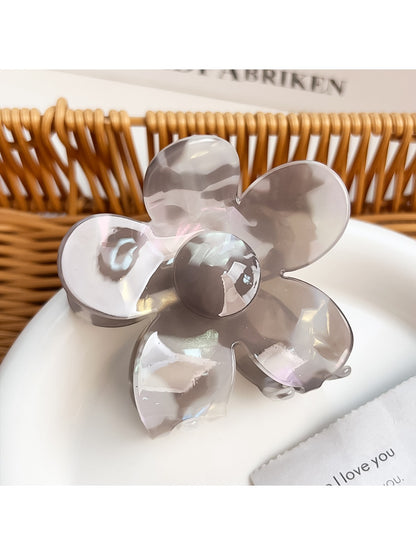 Close-up of flower hair claw clip clasp mechanism with colorful petal edges