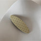 Beau hair clip displayed alongside other hair accessories in a flat lay