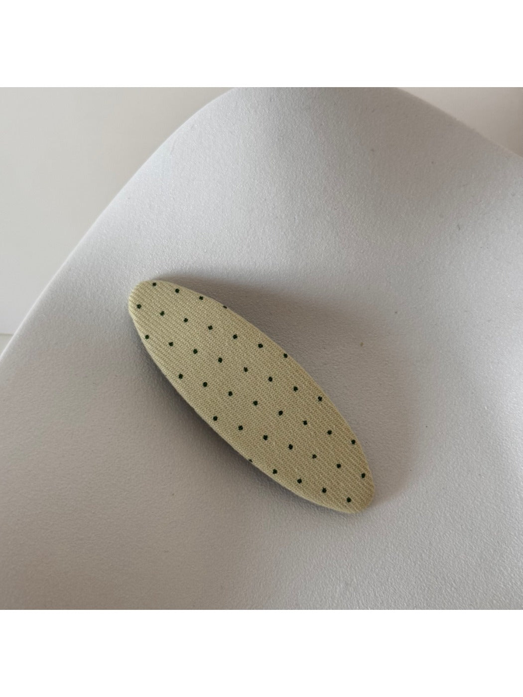 Beau hair clip displayed alongside other hair accessories in a flat lay