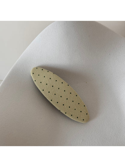 Beau hair clip displayed alongside other hair accessories in a flat lay