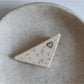 Beau triangle star hair clip clipped onto dark hair highlighting contrast and style