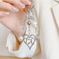 Heart shaped charm keychain with a metallic finish on a white background