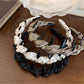 Close-up of Gifty satin polka dot headband showing smooth fabric texture