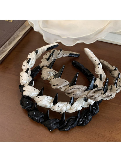Close-up of Gifty satin polka dot headband showing smooth fabric texture
