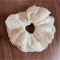 Gifty lace scrunchie wrapped around a ponytail on a model outdoors