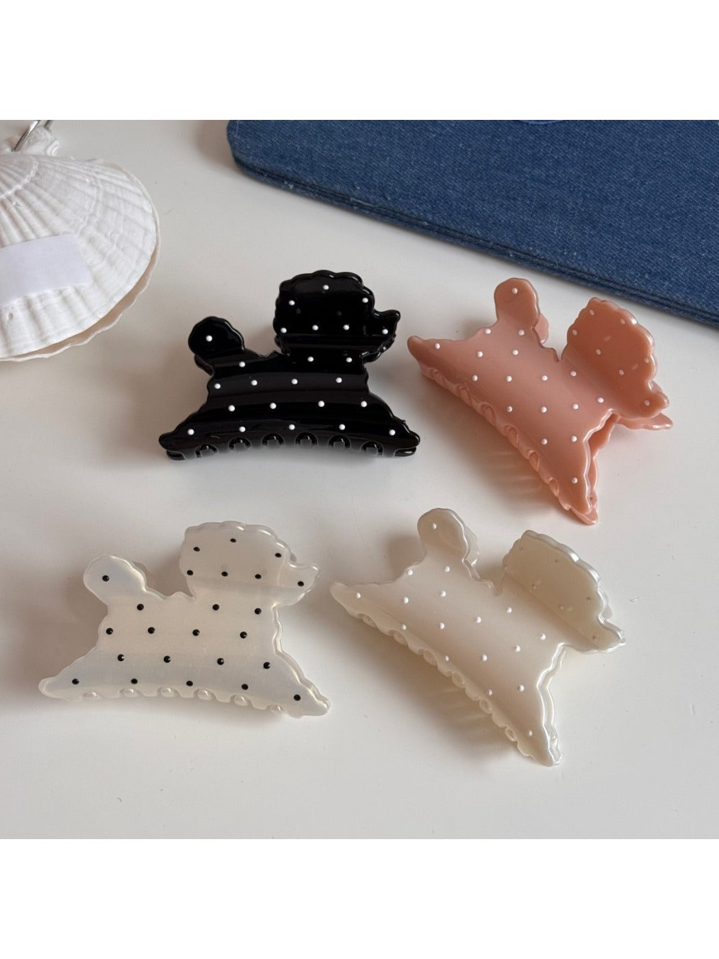 Close-up of Beau puppy hair clip showing detailed polka dot pattern and clip mechanism