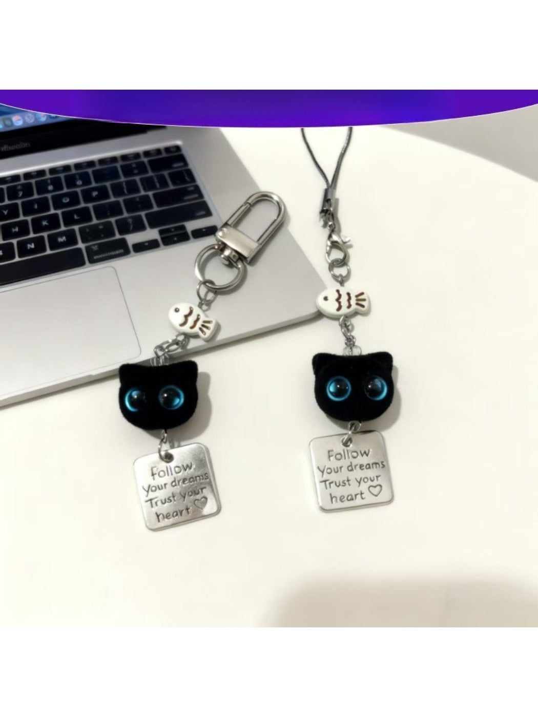 Blue eyed black cat keychain with detailed face and shiny finish