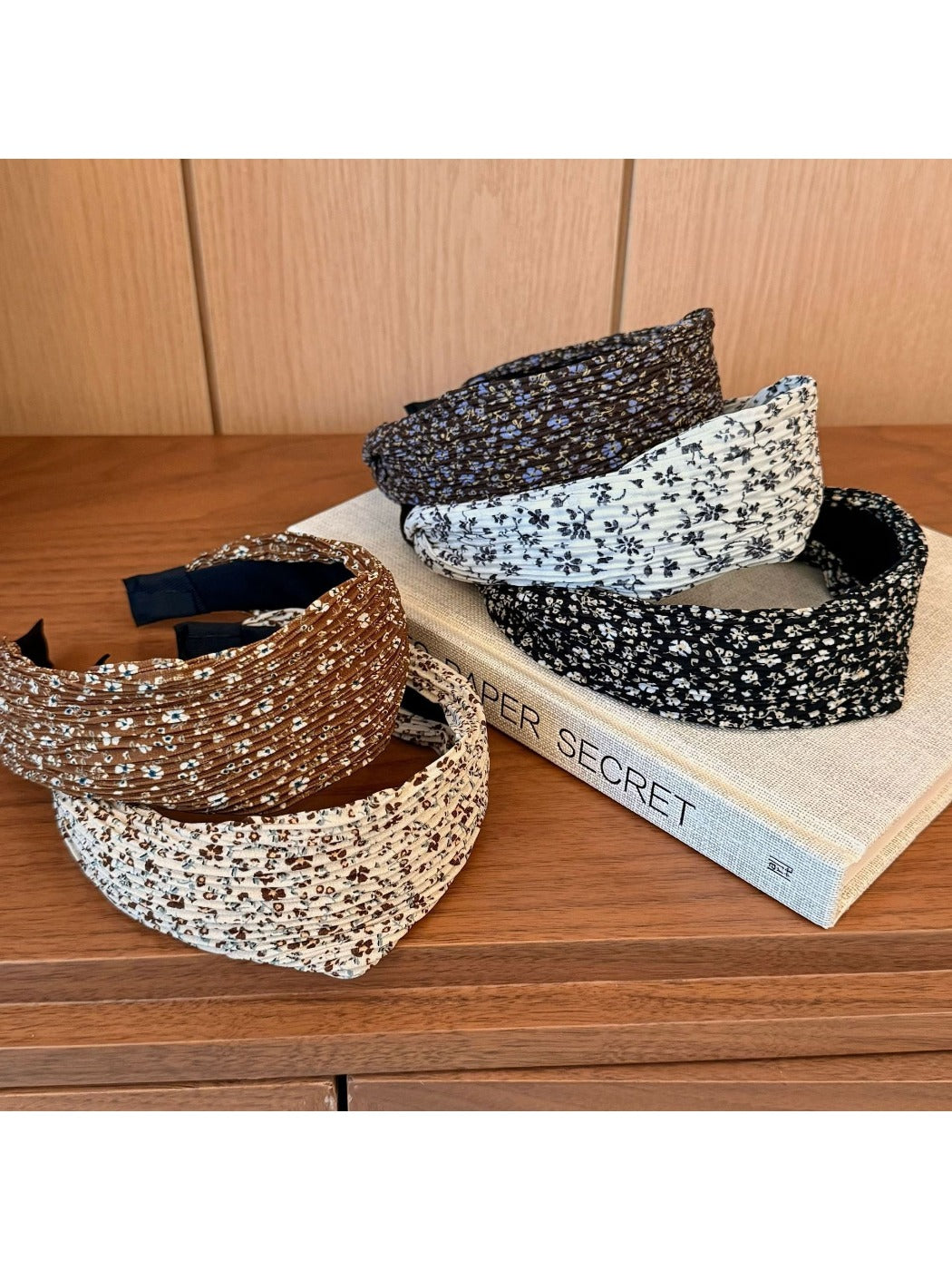Side view of wide vintage print headband showing fabric texture and colors