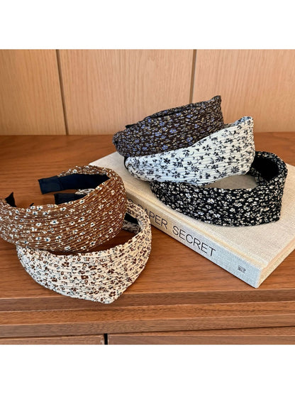 Side view of wide vintage print headband showing fabric texture and colors