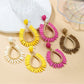 Close-up of Earedge minimalist oval raffia drop earrings on white background
